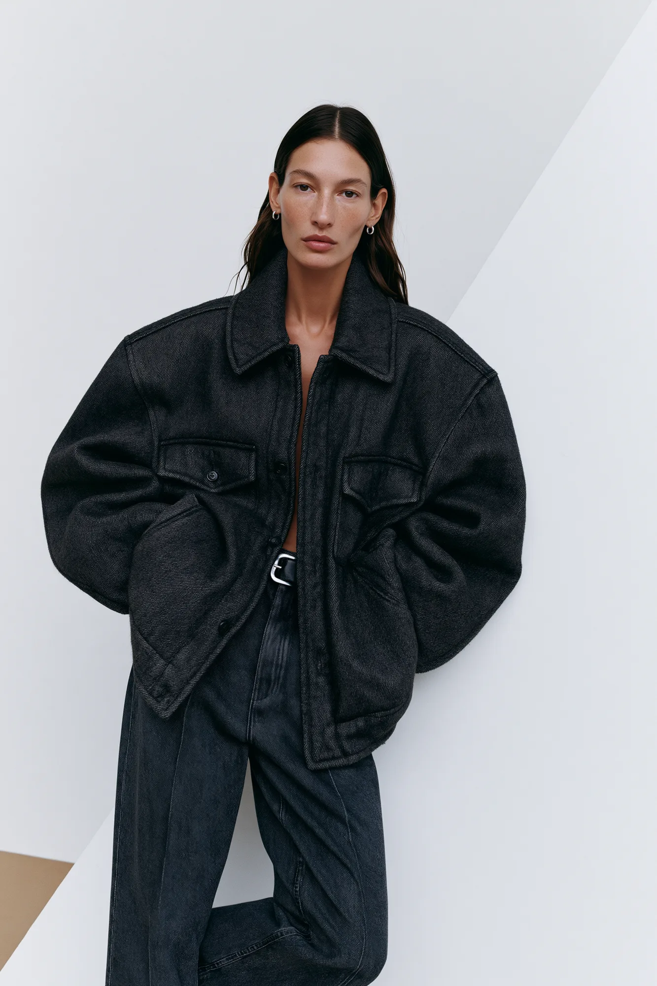 Oversized black denim look photographed frontally